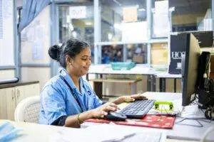 Woman works on a computer in an office.