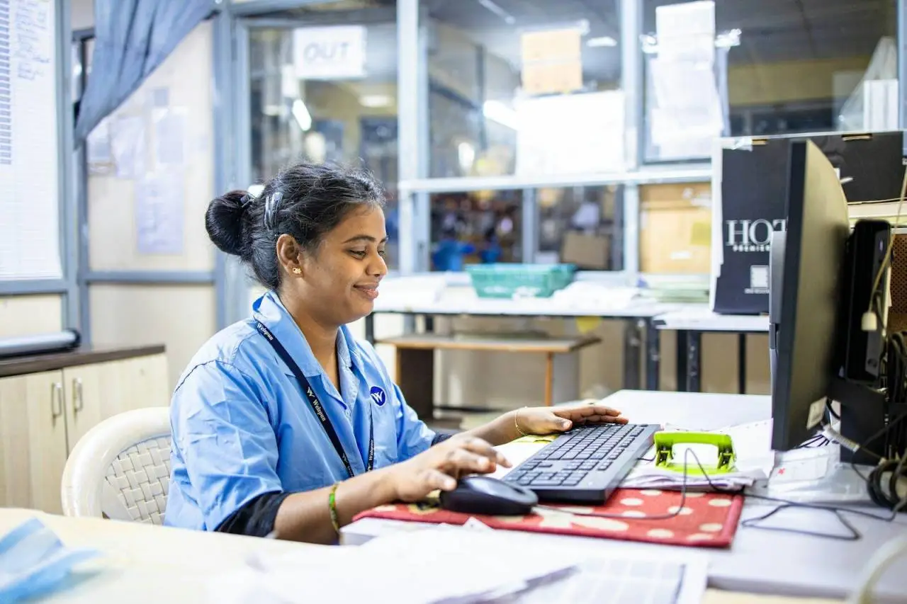 Woman works on a computer in an office.